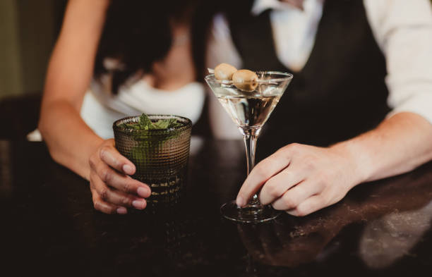 Man and woman at the bar with martini